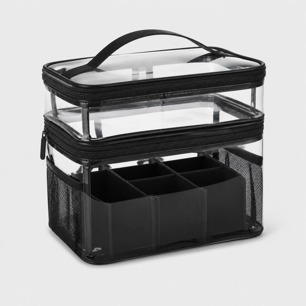 Beauty case transparent noir posé sur fond clair avec sa séparation intérieure