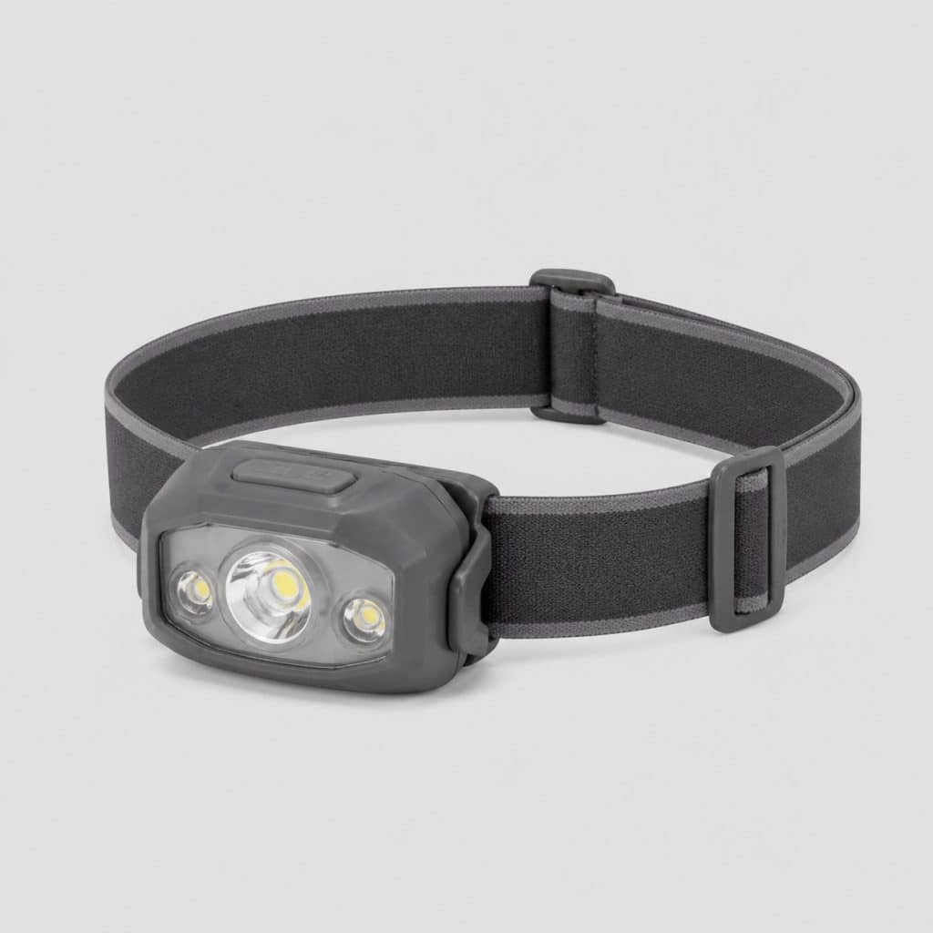 Lampe frontale compacte grise posée sur fond clair
