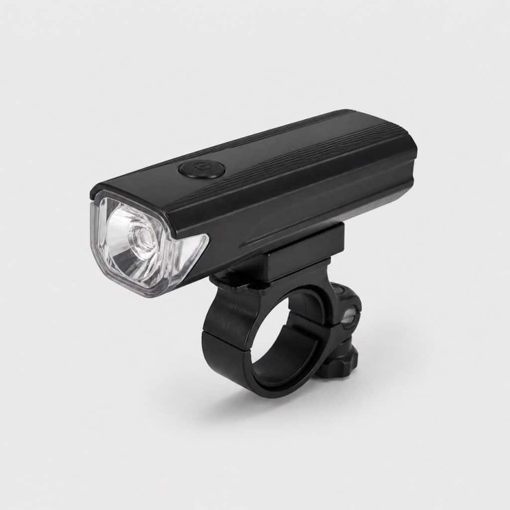 Lampe frontale noire pour vélo posée sur fond clair